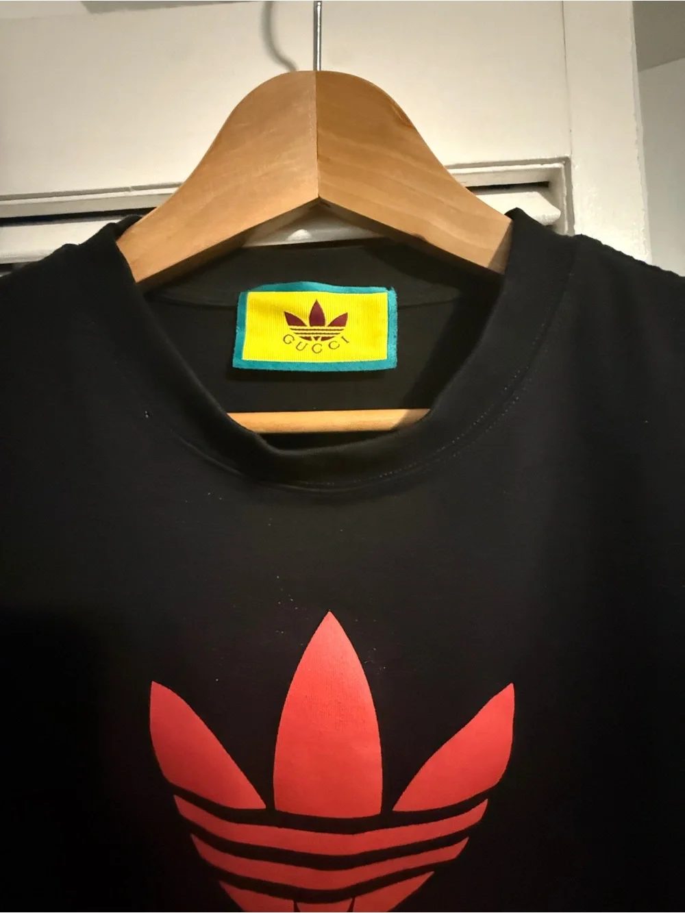 Gucci Black Tee with Red Trefoil Logo and Yellow Neck Label